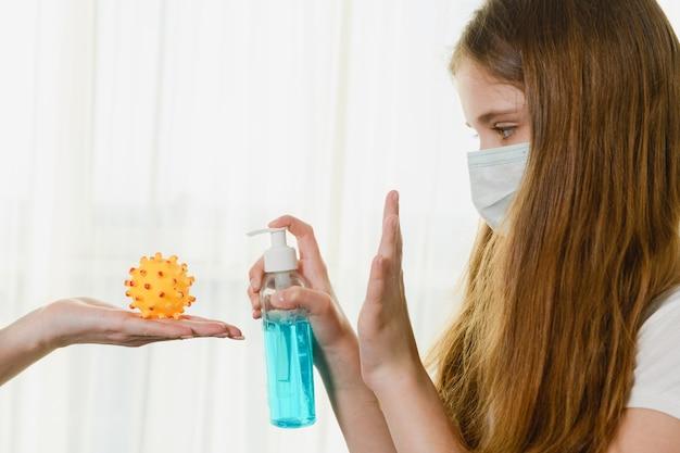 Young woman wearing a face mask using hand sanitizer to disinfect against virus